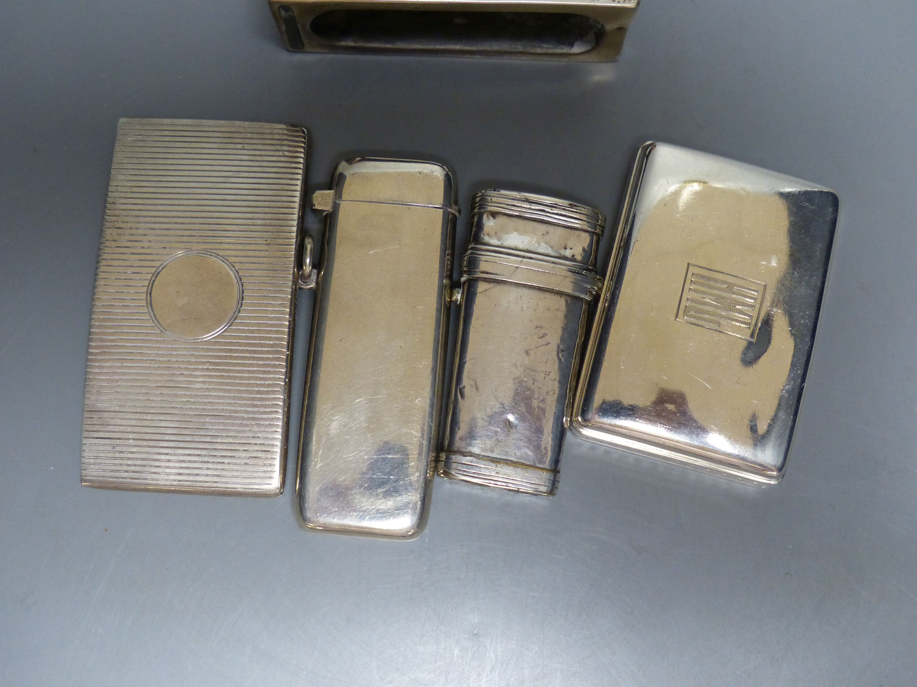 Two late Victorian silver diary cases, largest 85mm and seven other items including silver match sleeves & a silver fleam case.
